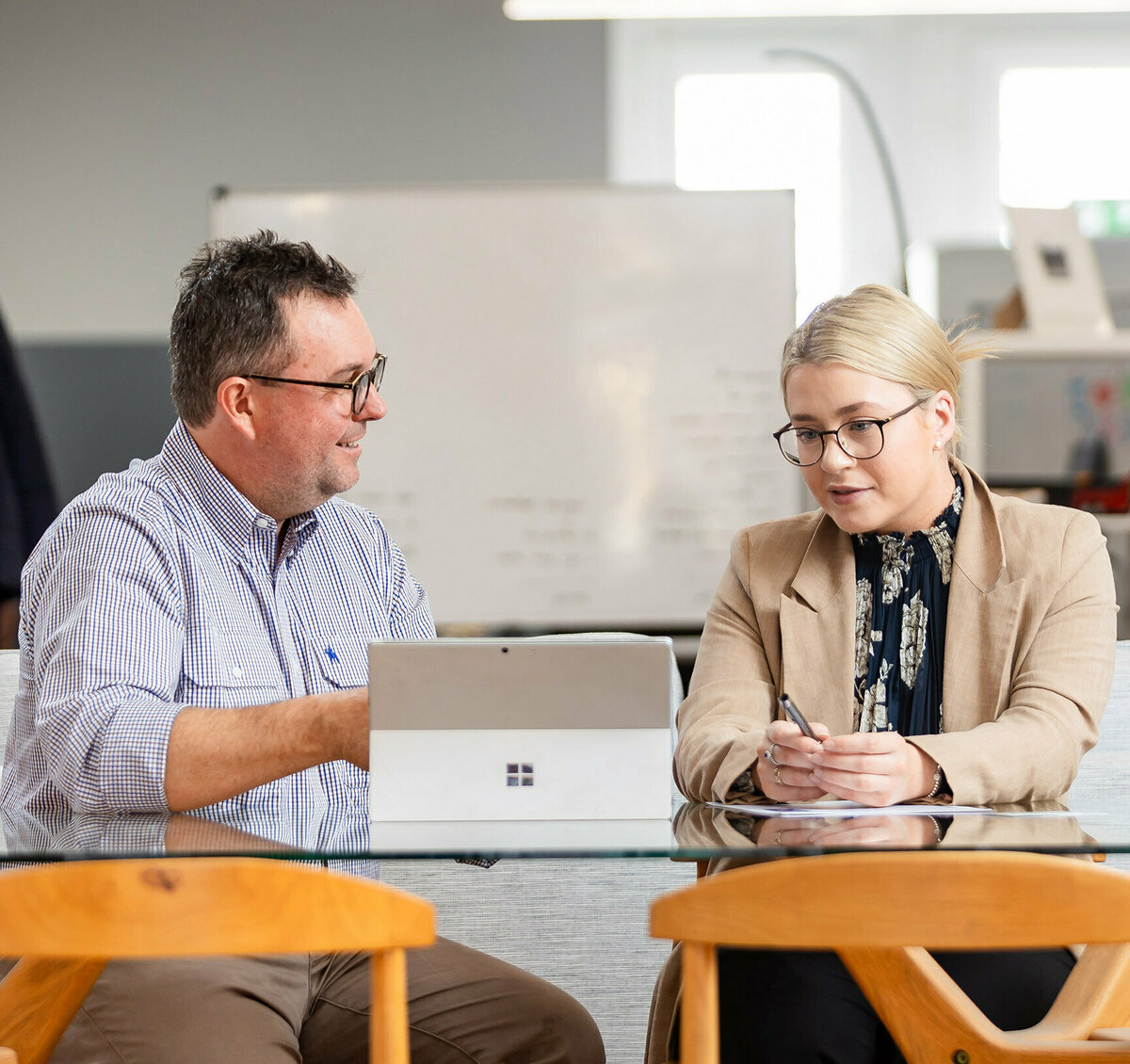 CACo. team member Peter is speaking with a client while explaining something on his computer.