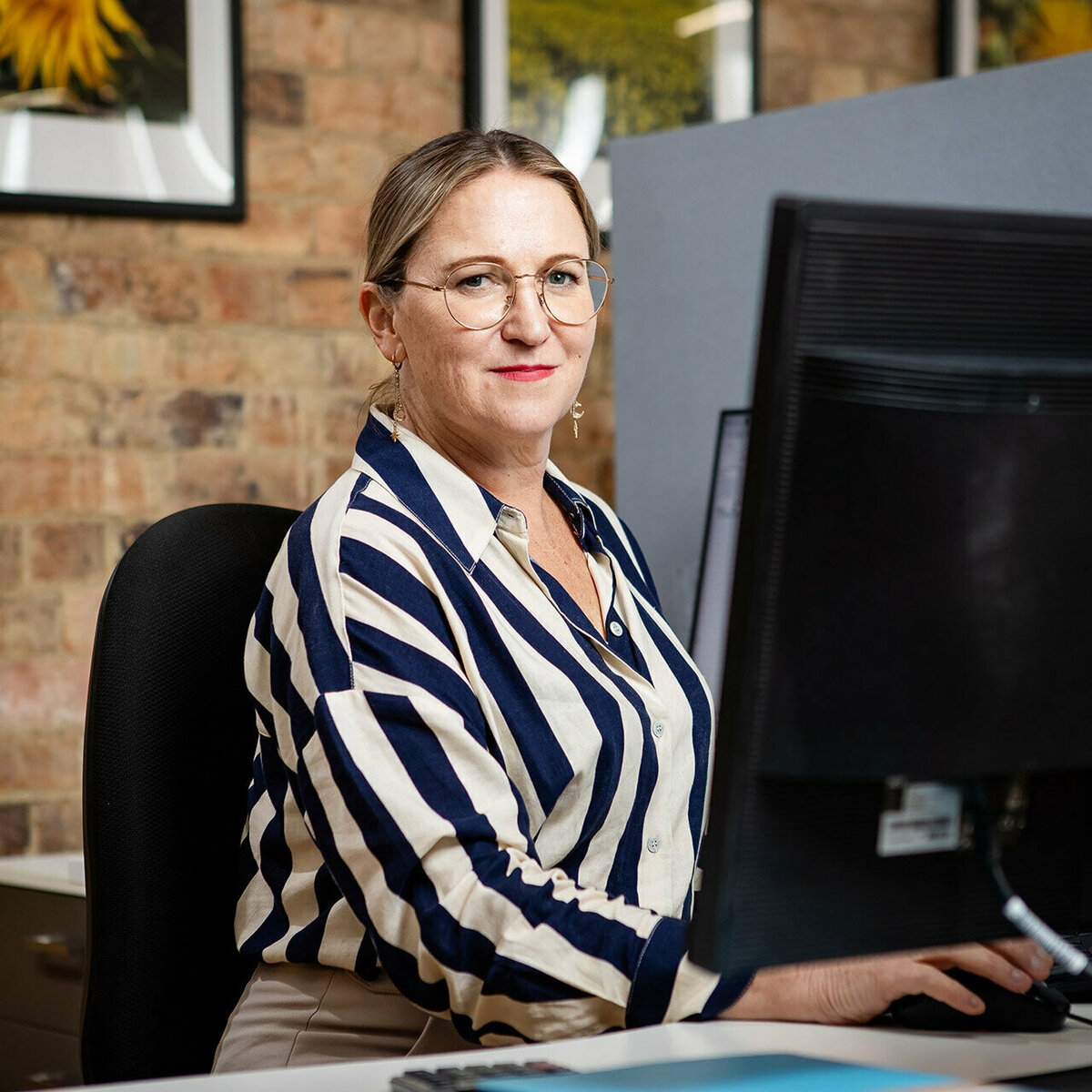 CACo. team member Erica sits at her desk.